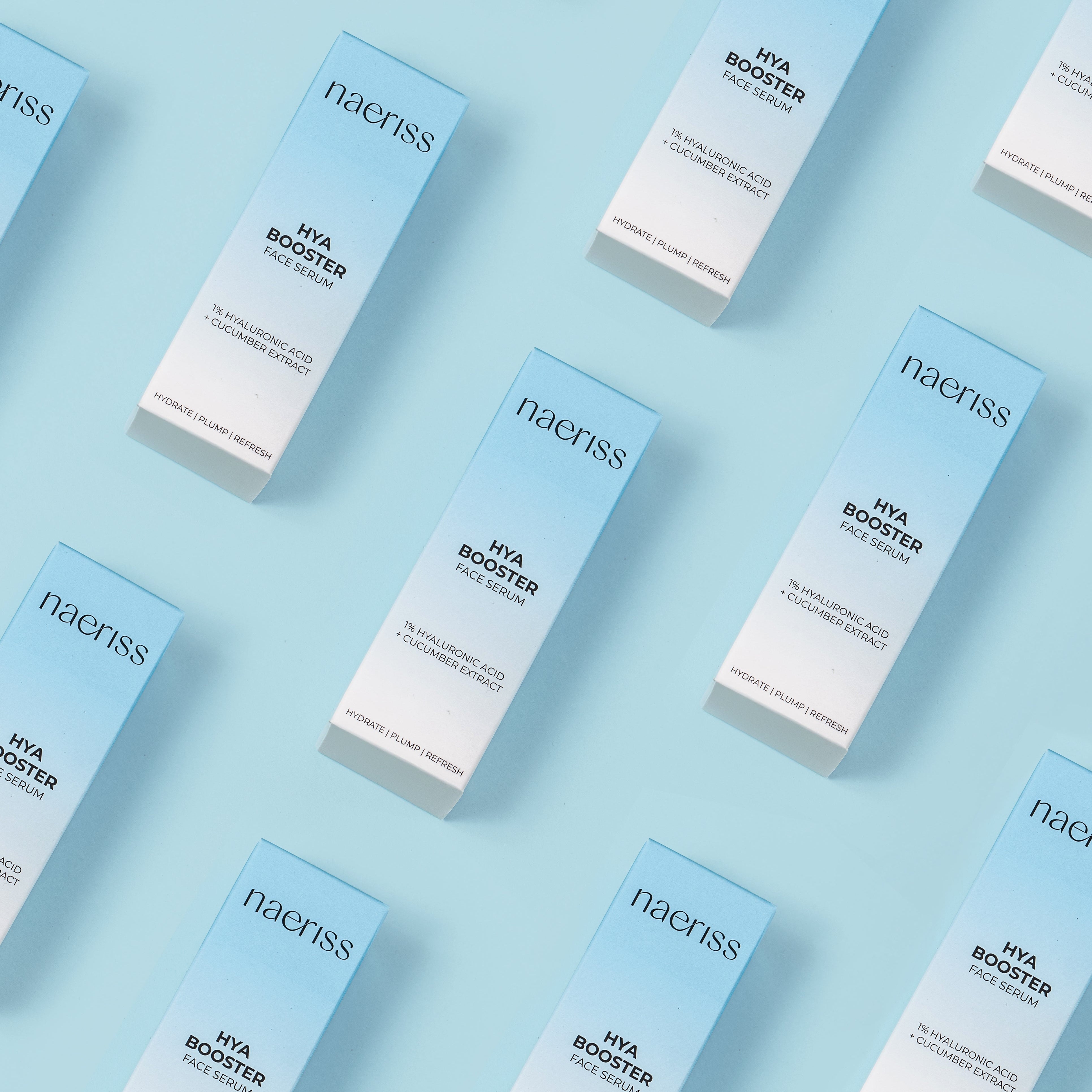 Multiple boxes of naeriss Hya Booster on a light blue background