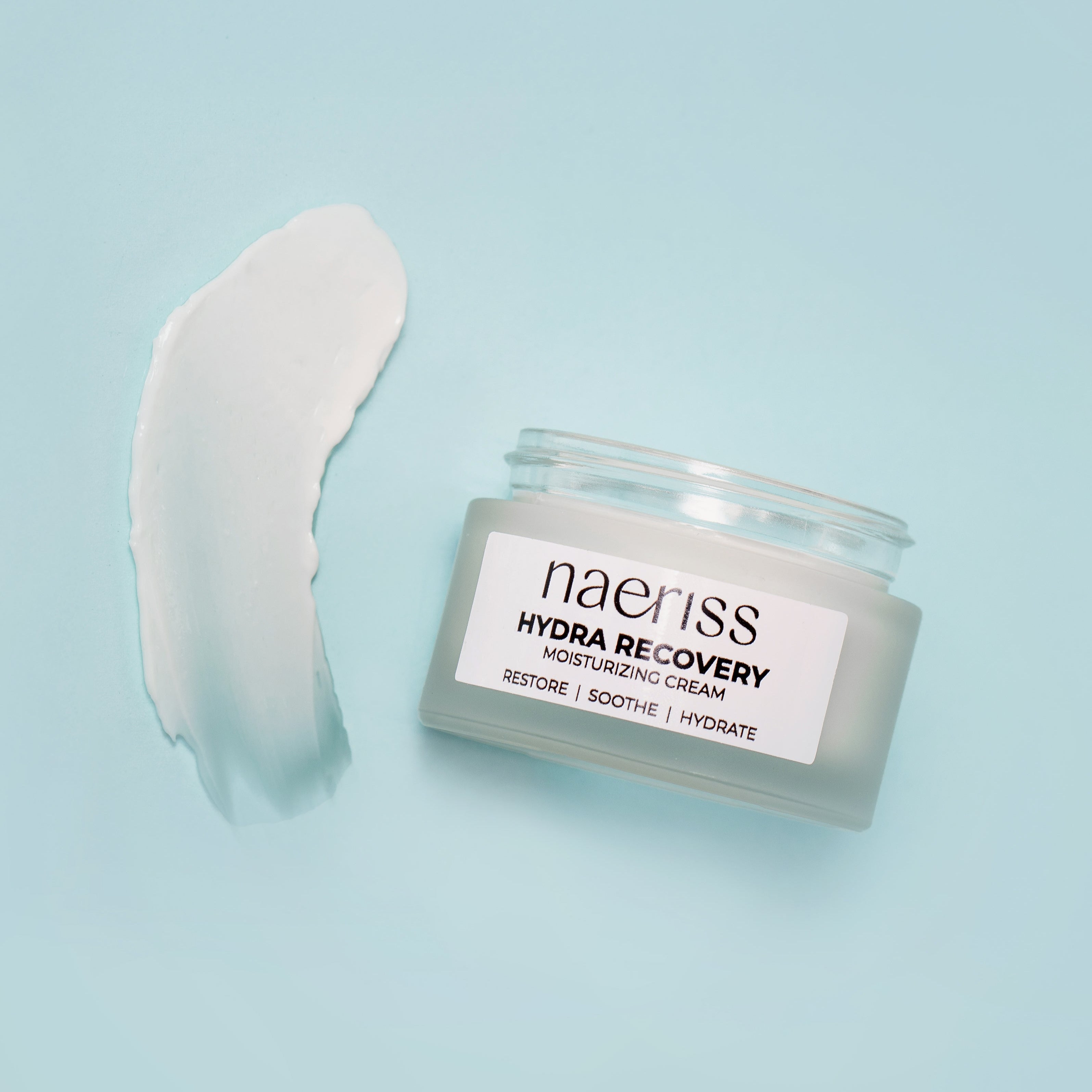Jar of naeriss Hydra Recovery cream with a swatch on a light blue background