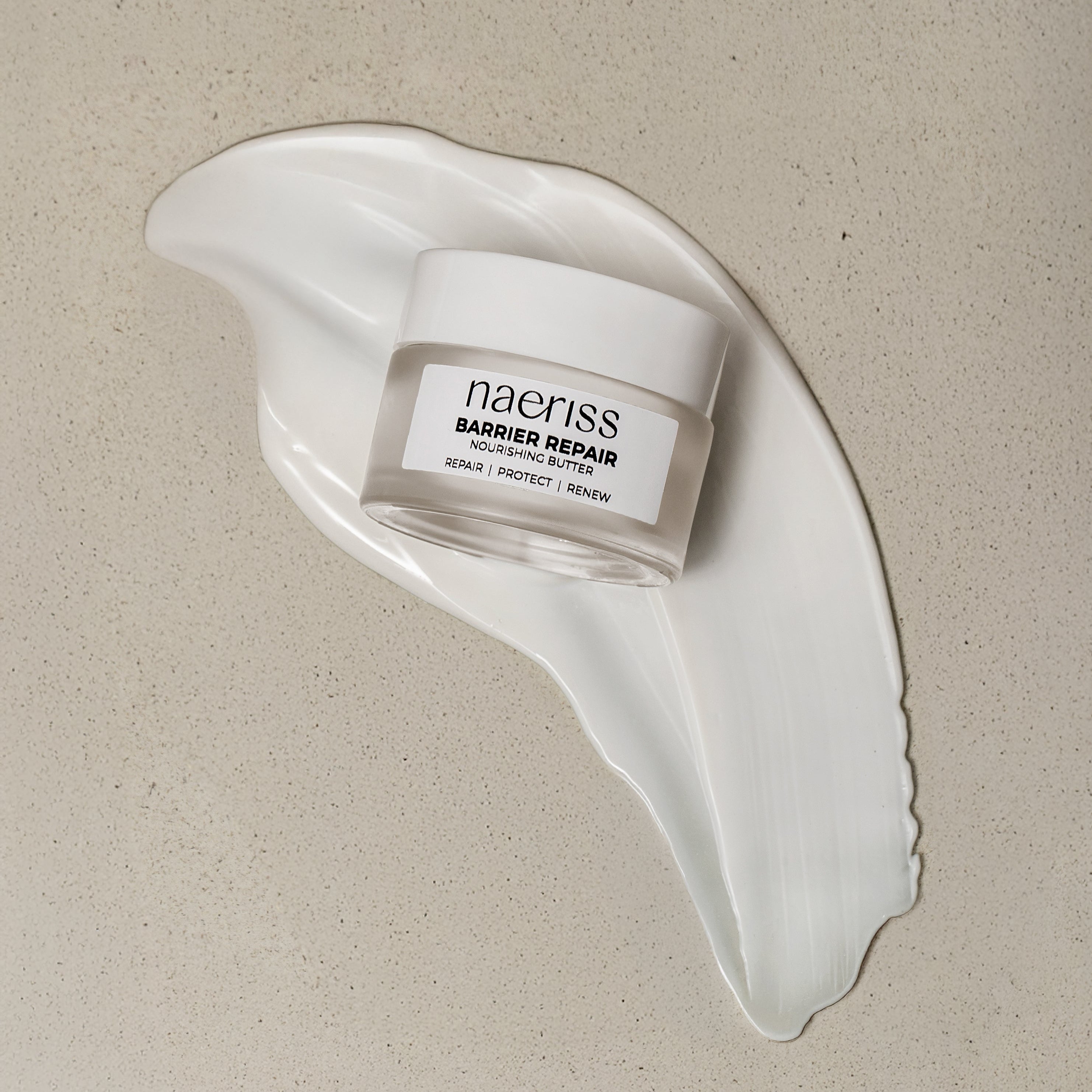 Skincare jar labeled 'naeriss' on a beige background with a white cream smear.