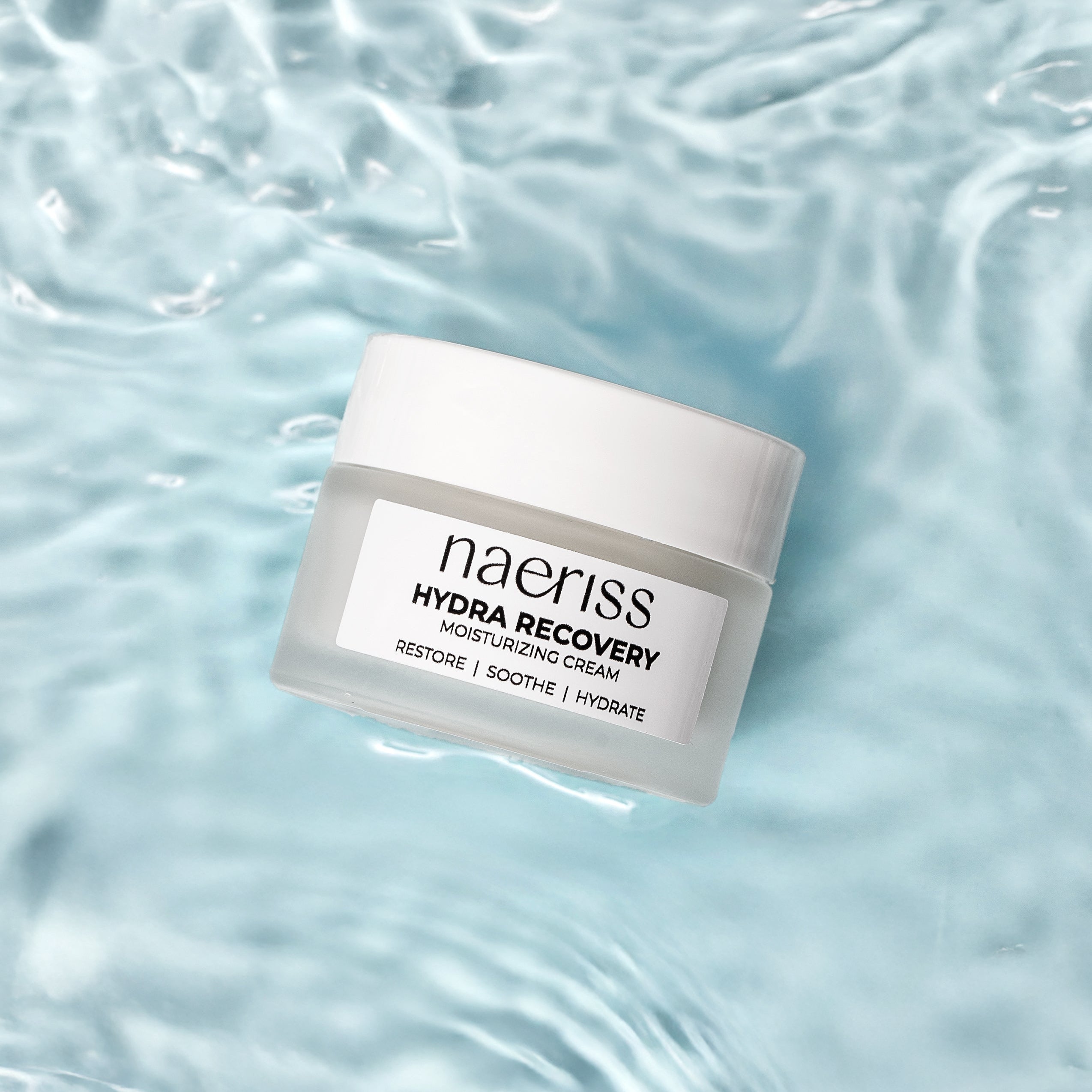 Naeiriss Hydra Recovery cream jar on a water background